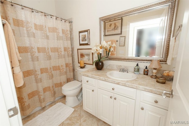 bathroom featuring tile patterned floors, toilet, and vanity