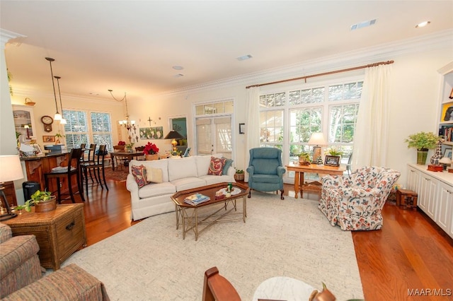 living room with hardwood / wood-style floors and crown molding