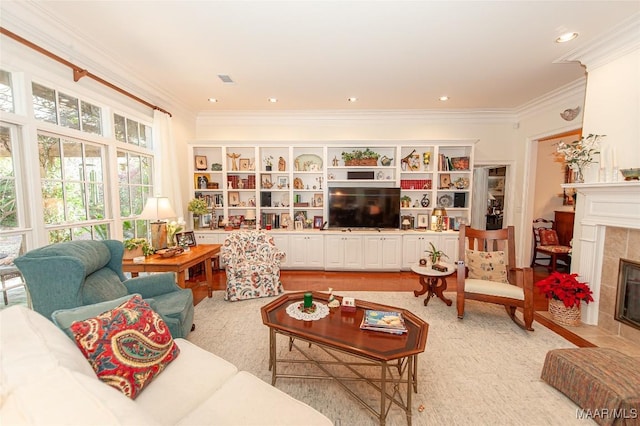 living room featuring a tile fireplace and crown molding