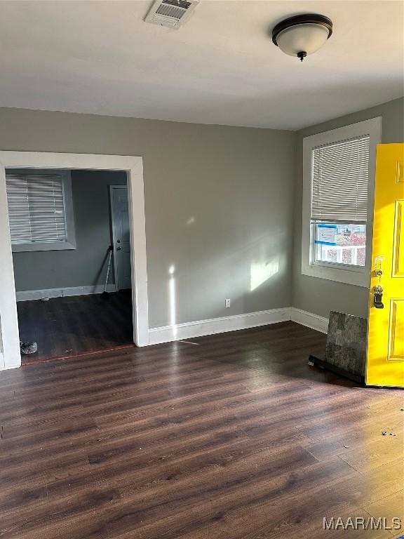 spare room featuring dark wood-type flooring