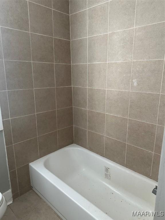 bathroom with tile patterned floors and toilet