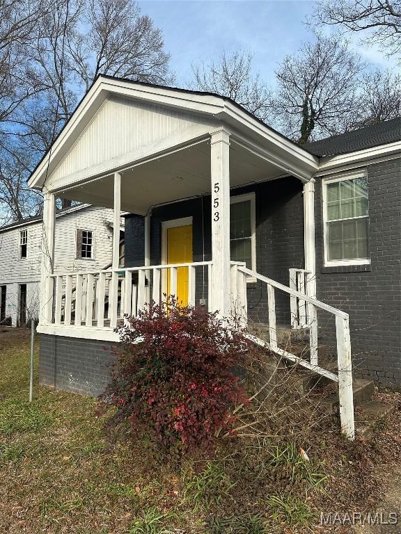 view of side of property with covered porch