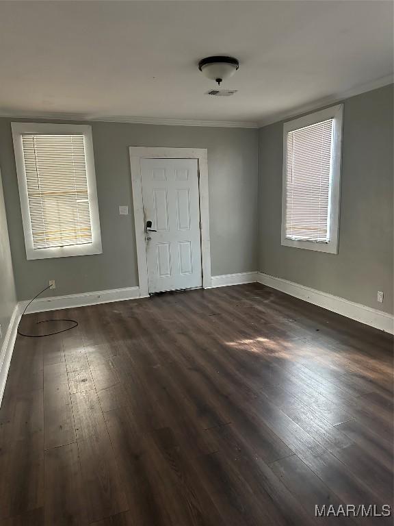 entryway with crown molding and dark hardwood / wood-style floors