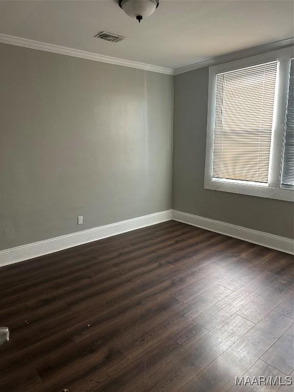 unfurnished room featuring dark hardwood / wood-style flooring and ornamental molding