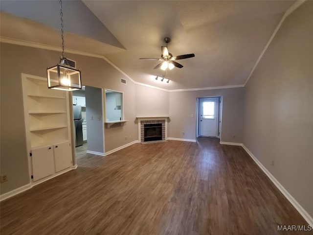 unfurnished living room featuring dark wood-type flooring, lofted ceiling, built in features, ceiling fan, and a fireplace