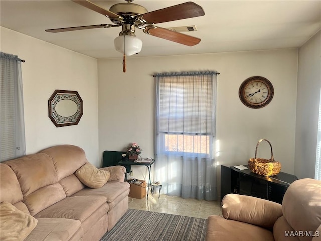 living room with light tile patterned floors and ceiling fan