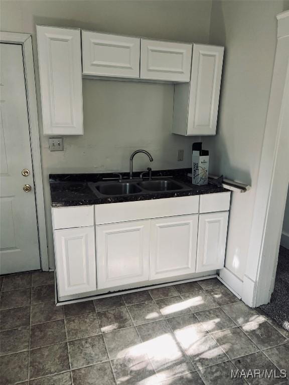 kitchen featuring white cabinetry and sink