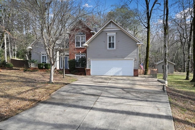 view of front of property with brick siding, driveway, fence, and a garage