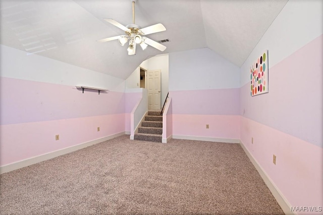 bonus room with carpet, lofted ceiling, visible vents, ceiling fan, and baseboards