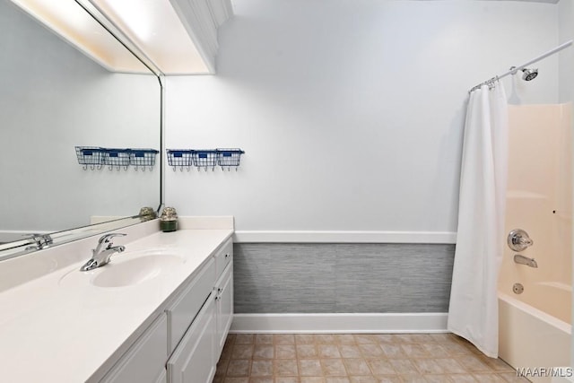 bathroom with shower / bath combination with curtain, vanity, and baseboards