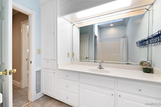 full bath with a shower with curtain, vanity, and baseboards