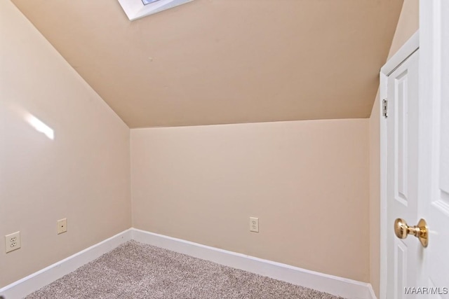 bonus room featuring lofted ceiling with skylight, carpet flooring, and baseboards