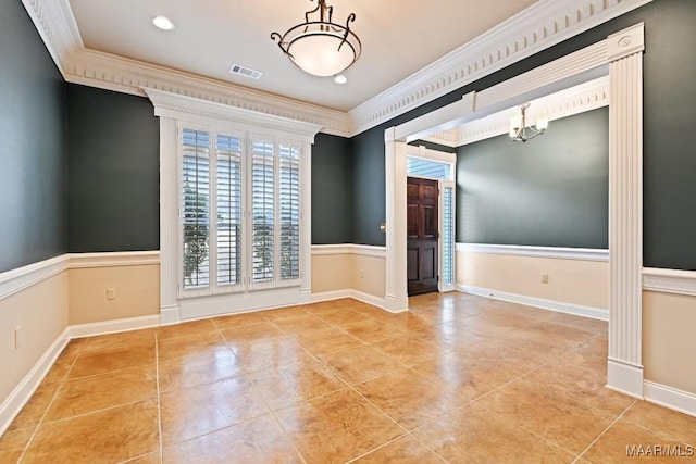 empty room with tile patterned floors, visible vents, a chandelier, and ornamental molding