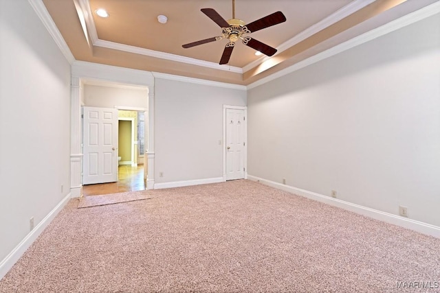 carpeted empty room with recessed lighting, a ceiling fan, baseboards, a tray ceiling, and crown molding