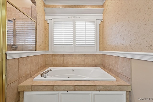 bathroom featuring a tub with jets and crown molding