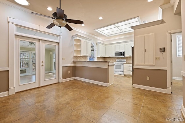 kitchen with white electric range oven, white cabinets, stainless steel microwave, a peninsula, and open shelves