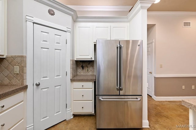 kitchen with high end fridge, visible vents, ornamental molding, white cabinets, and light tile patterned flooring