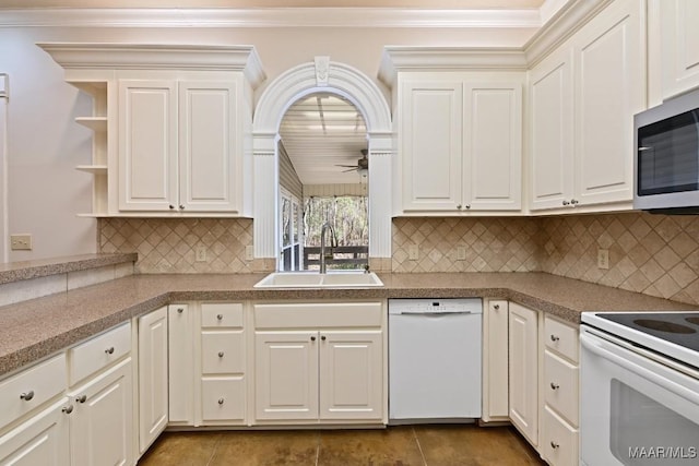 kitchen with white appliances, crown molding, ceiling fan, and a sink