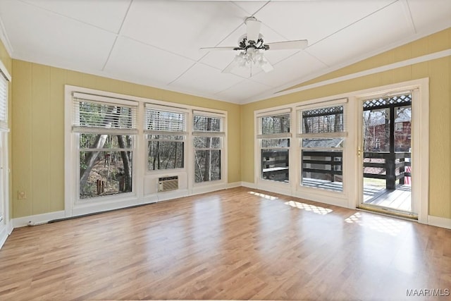 unfurnished sunroom featuring ceiling fan, vaulted ceiling, and a wealth of natural light