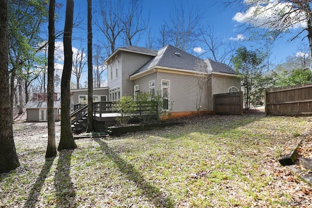 view of property exterior with a wooden deck and a lawn