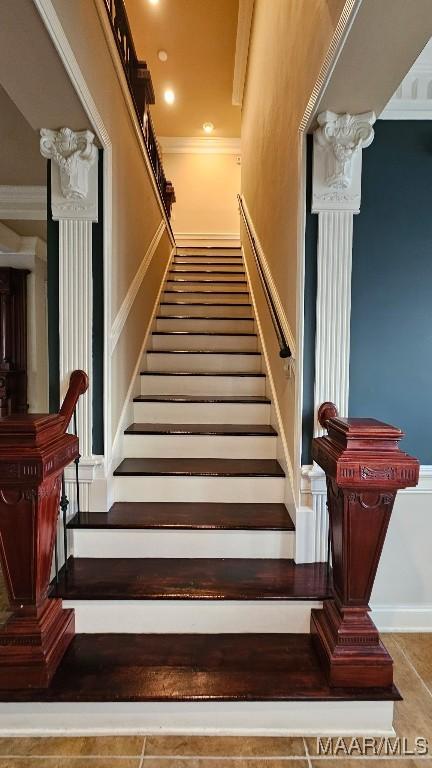 staircase featuring ornamental molding