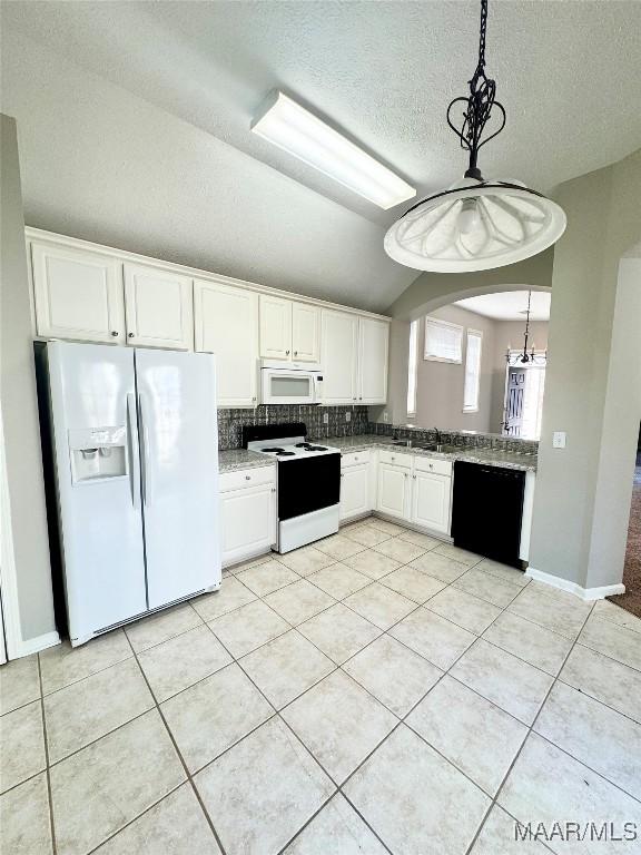 kitchen featuring lofted ceiling, a textured ceiling, pendant lighting, white appliances, and white cabinets