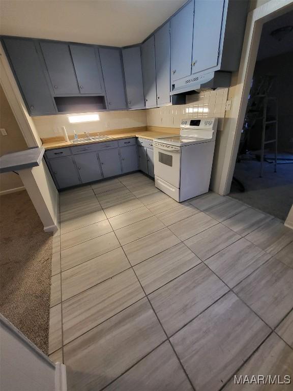 kitchen featuring sink, white electric range, and light tile patterned floors