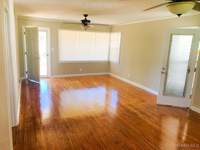 empty room with ornamental molding, ceiling fan, and light hardwood / wood-style floors