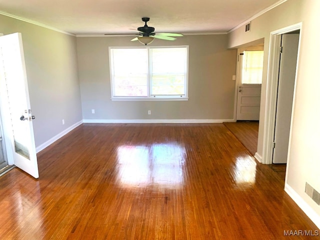 spare room featuring crown molding, dark hardwood / wood-style floors, and ceiling fan