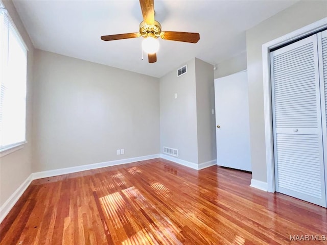 unfurnished bedroom featuring a closet, ceiling fan, and light hardwood / wood-style flooring