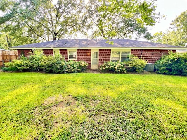 view of front of property featuring central AC unit and a front lawn