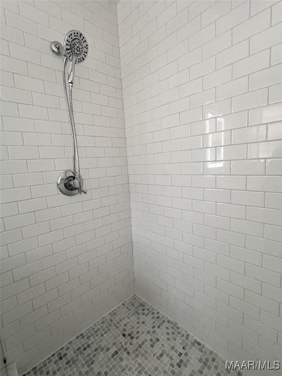 bathroom with tiled shower