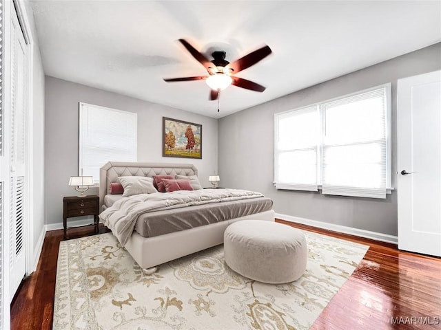 bedroom with dark wood-type flooring and ceiling fan