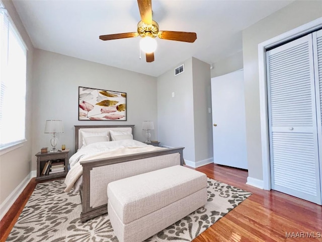 bedroom featuring hardwood / wood-style flooring, a closet, and ceiling fan