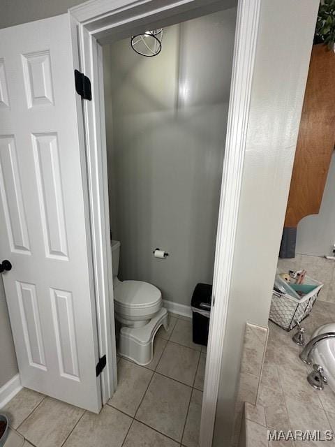 bathroom with tile patterned flooring and toilet