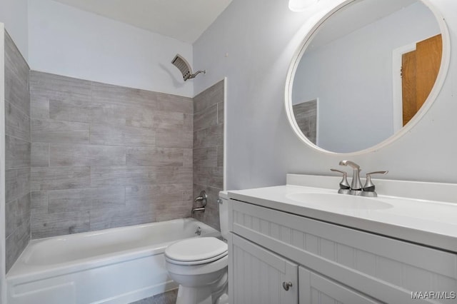 full bathroom featuring tiled shower / bath combo, vanity, and toilet