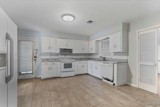 kitchen featuring white appliances, sink, light hardwood / wood-style flooring, and white cabinets