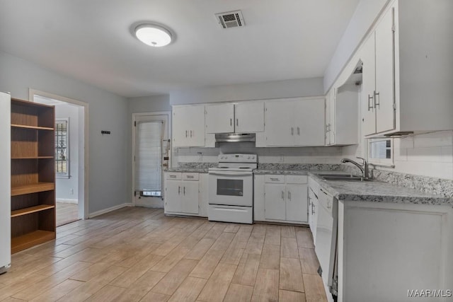 kitchen with sink, white appliances, white cabinetry, light hardwood / wood-style floors, and decorative backsplash