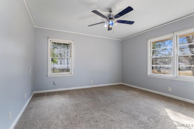 empty room with crown molding, carpet flooring, and a wealth of natural light