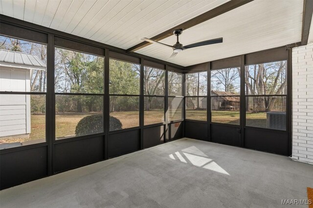 unfurnished sunroom with ceiling fan