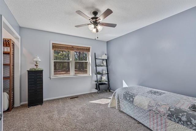 bedroom featuring ceiling fan, carpet flooring, and a textured ceiling