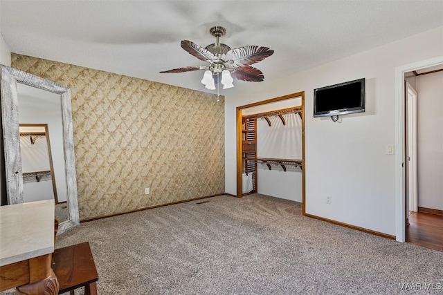 unfurnished bedroom with carpet, ceiling fan, and a closet