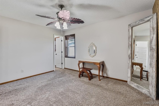 unfurnished room featuring ceiling fan, carpet, and a textured ceiling