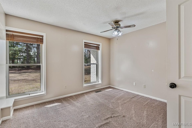 spare room with ceiling fan, carpet floors, and a textured ceiling