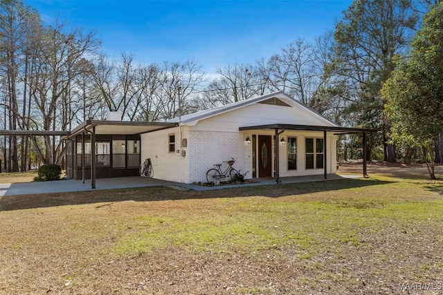 view of front facade with a carport and a front yard