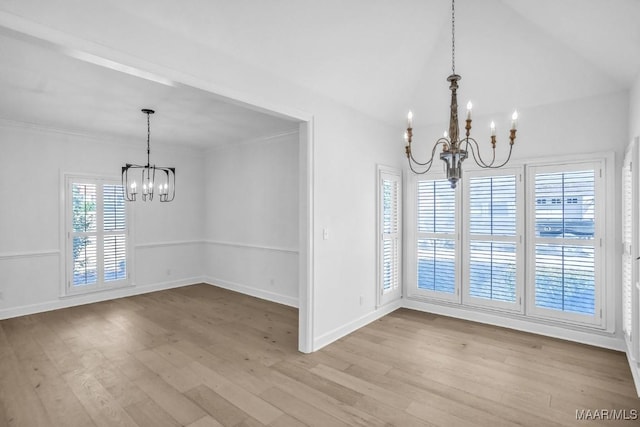 unfurnished dining area featuring an inviting chandelier and light hardwood / wood-style floors