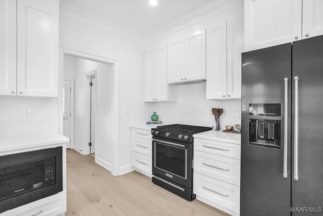 kitchen featuring white cabinetry, light hardwood / wood-style flooring, and black appliances