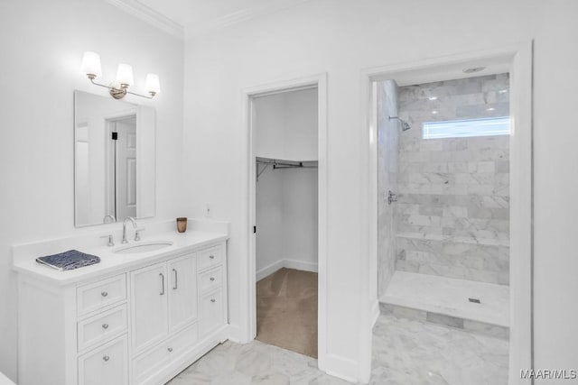 bathroom featuring tiled shower, ornamental molding, and vanity