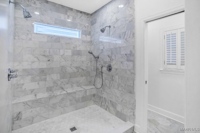 bathroom with a tile shower