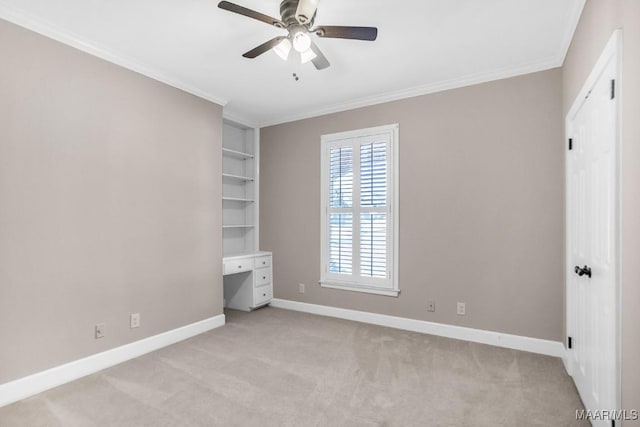 unfurnished bedroom featuring ornamental molding, light colored carpet, and ceiling fan